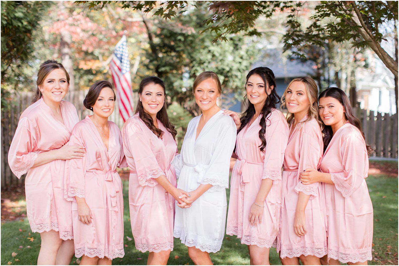 bridesmaids in pink robes pose for Idalia Photography