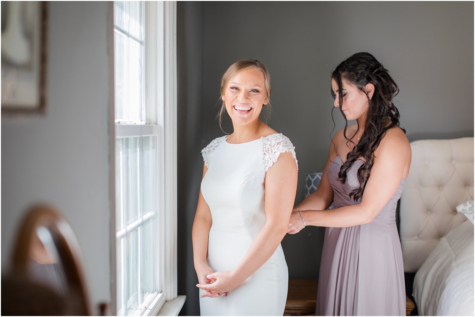 bride gets into wedding dress with Idalia Photography