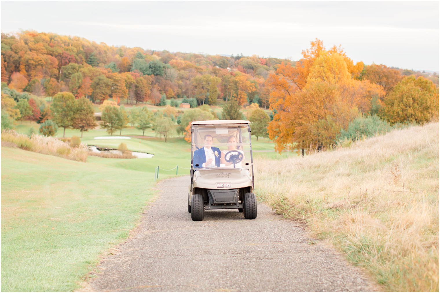 New York Country Club wedding photos of bride and groom in golf cart