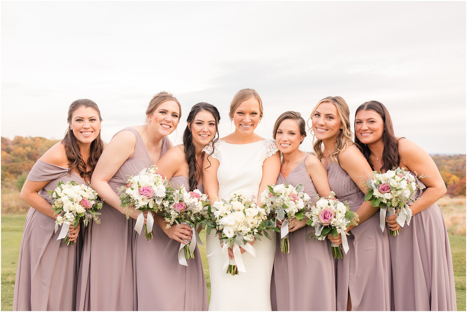 bridesmaids in mauve gowns pose for Idalia Photography