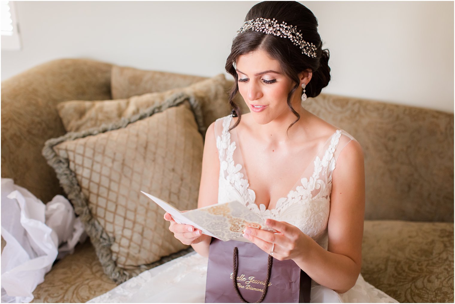 bride opens gift on wedding day photographed by Idalia Photography
