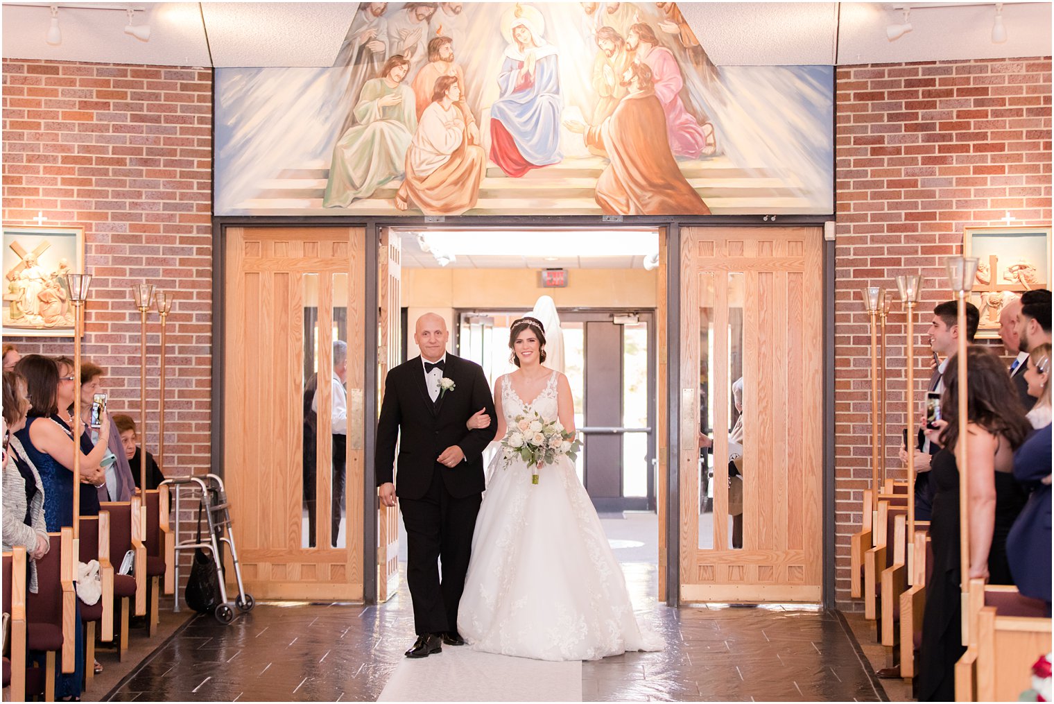 bride enters church on wedding day with father photographed by Idalia Photography