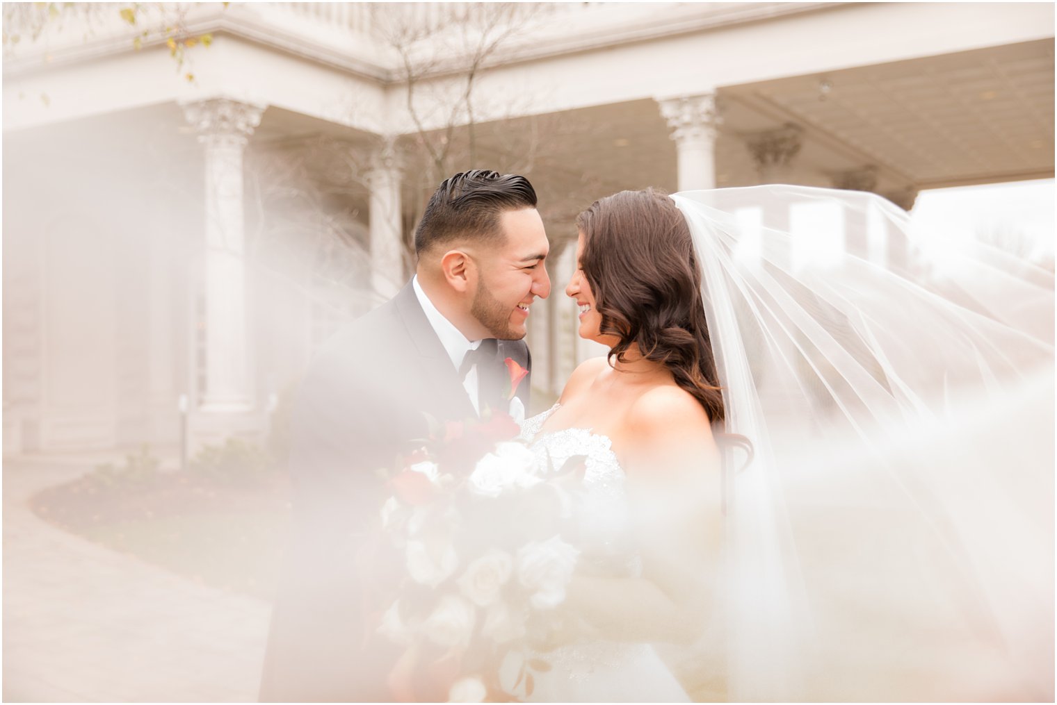 dramatic wedding portraits with veil photographed by Idalia Photography