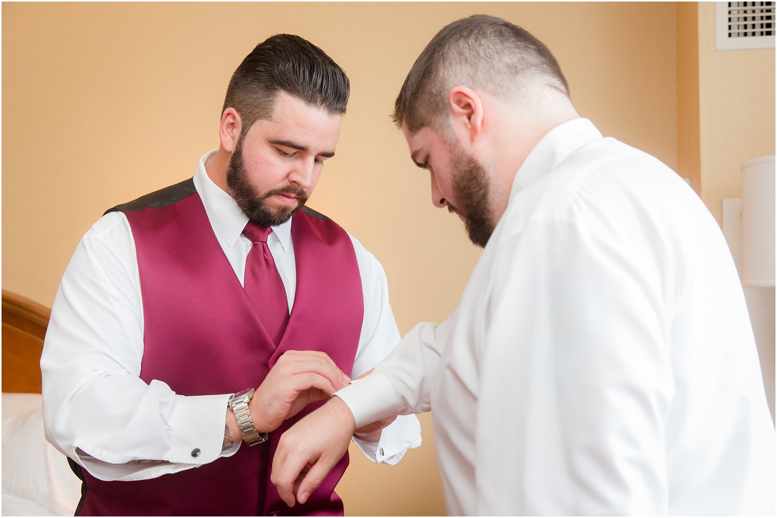 Idalia Photography captures groom preparing for Ryland Inn coach house wedding photos