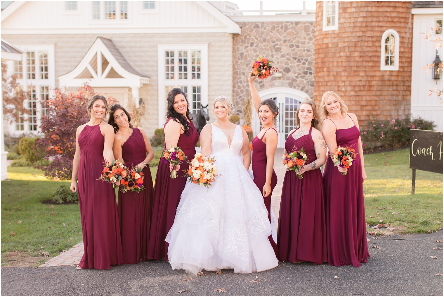 bride with bridesmaids in burgundy gowns photographed by Idalia Photography