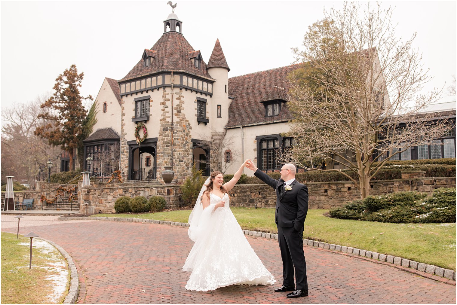 groom twirling bride at Pleasantdale Chateau winter wedding