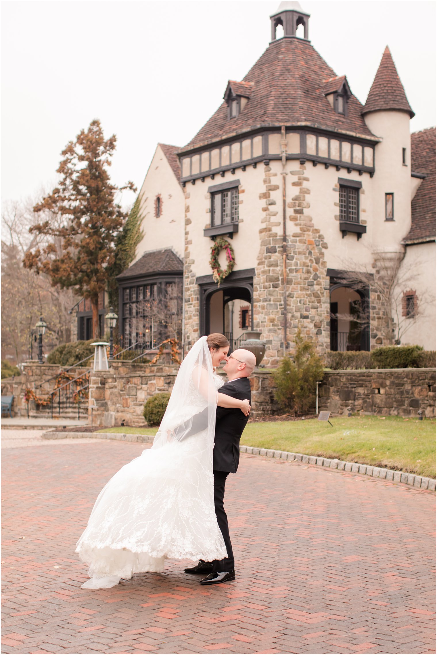 groom lifting bride at Pleasantdale Chateau winter wedding