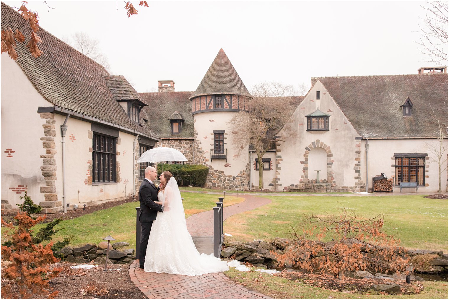 rainy wedding at Pleasantdale Chateau | photos of bride and groom with umbrella