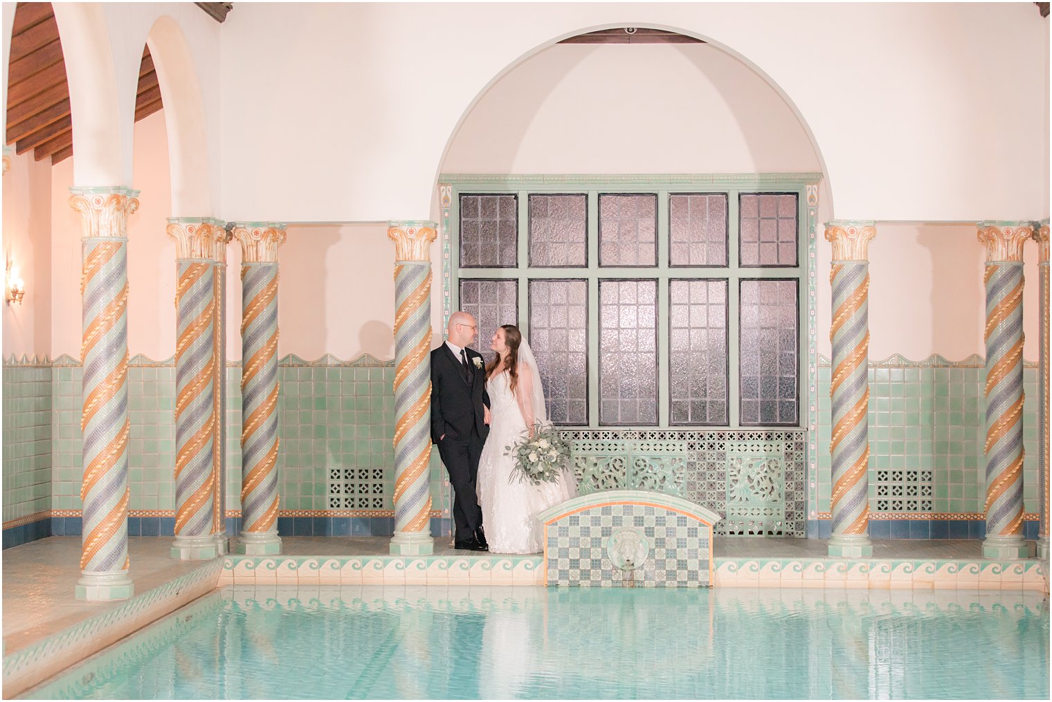 bride and groom wedding photo at pool at Pleasantdale Chateau