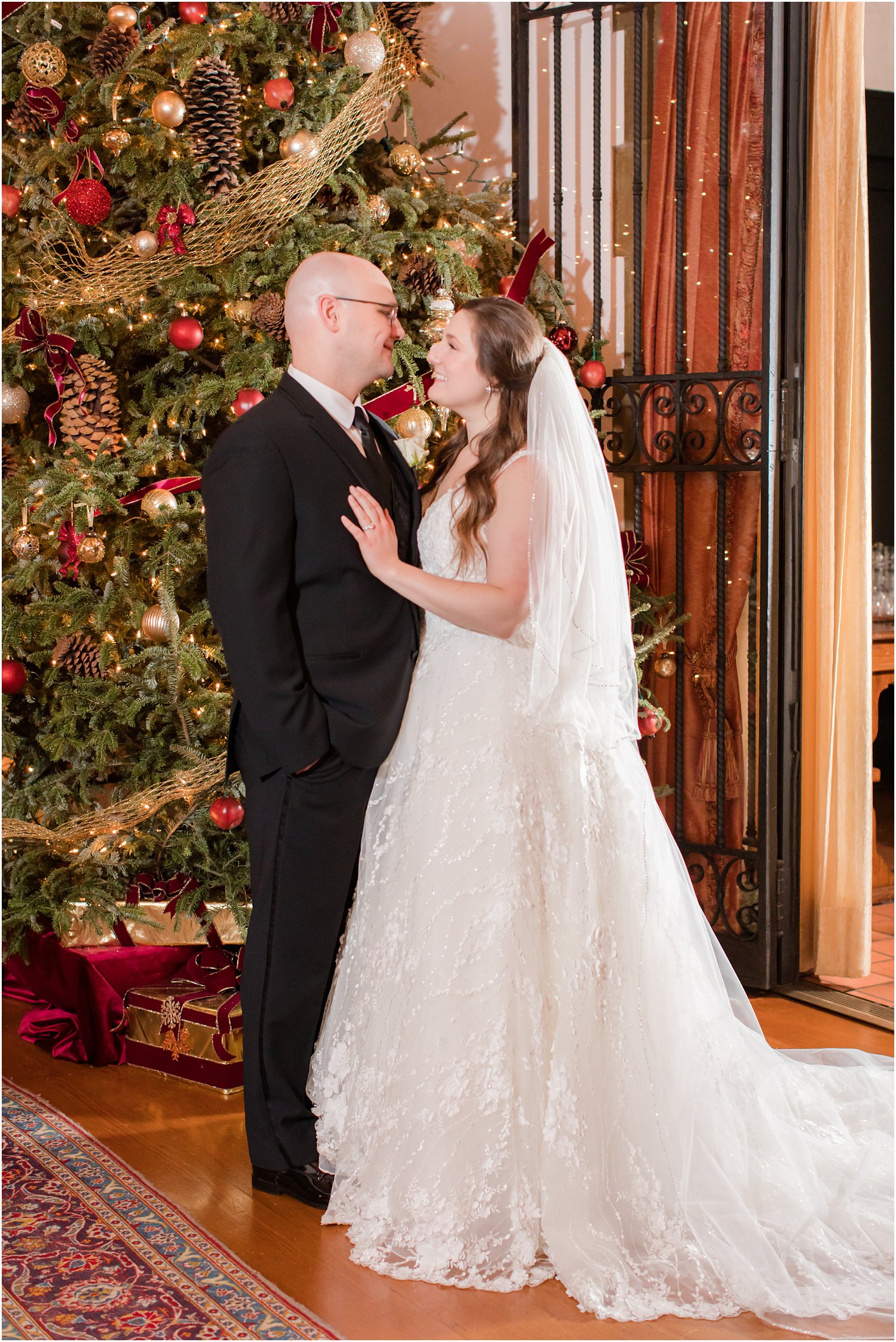 Bride and groom in front of Christmas Tree