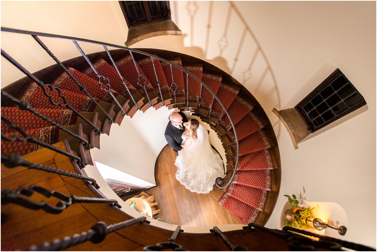 romantic wedding photo in spiral staircase at Pleasantdale Chateau winter wedding