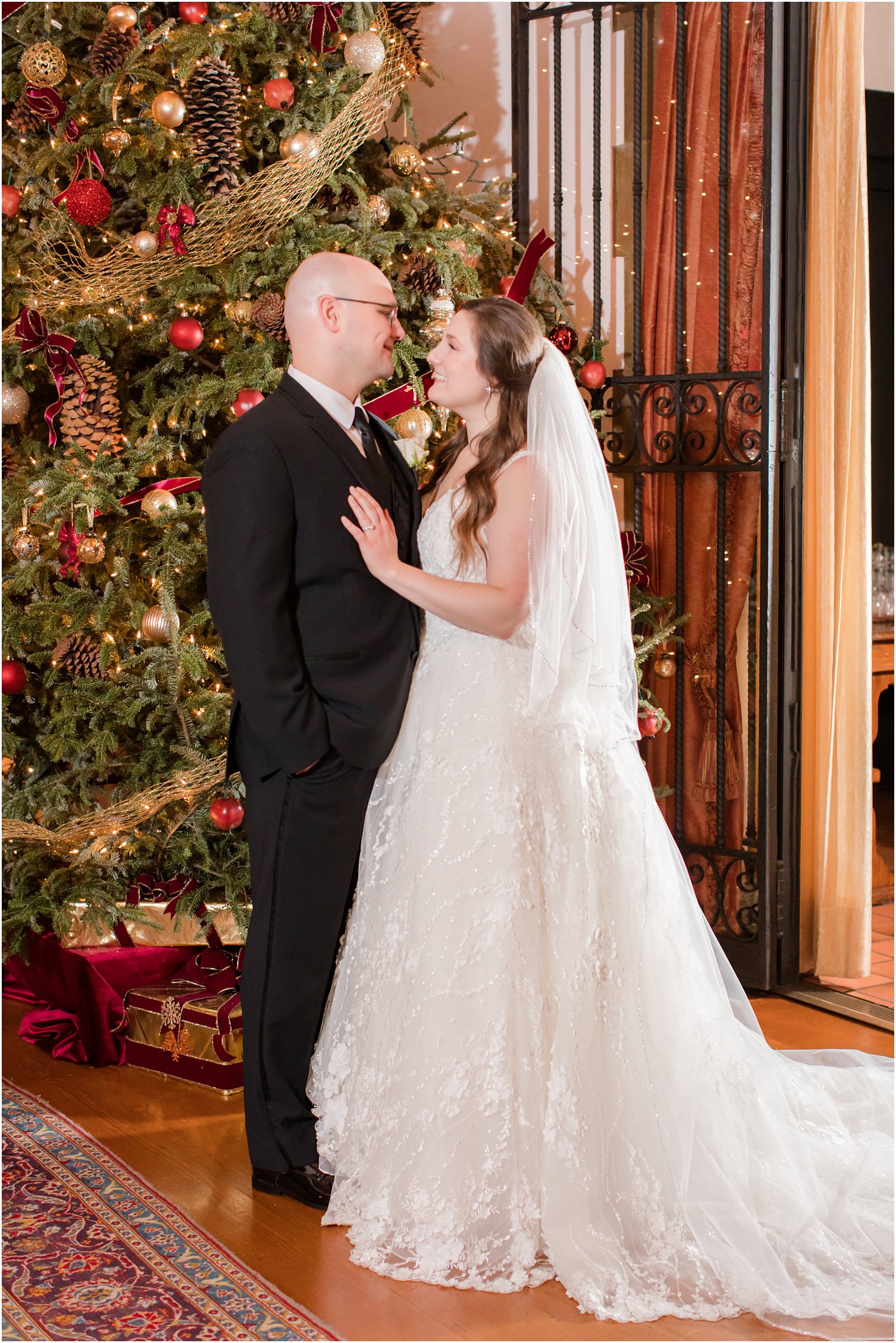 couple posing with Christmas tree at Pleasantdale Chateau