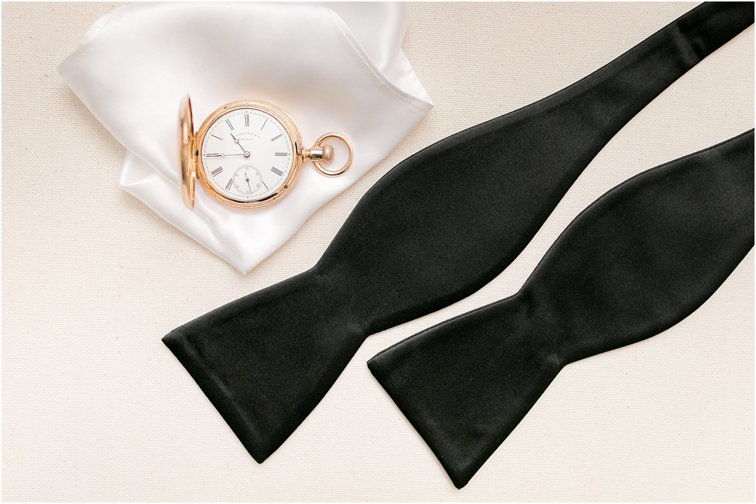 Groom's details for black tie wedding including gold pocket watch