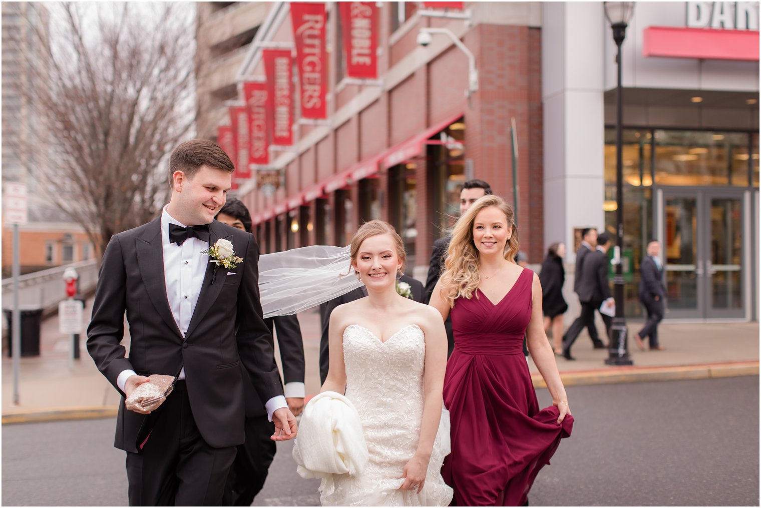 Candid photo of bride and groom walking in downtown New Brunswick NJ