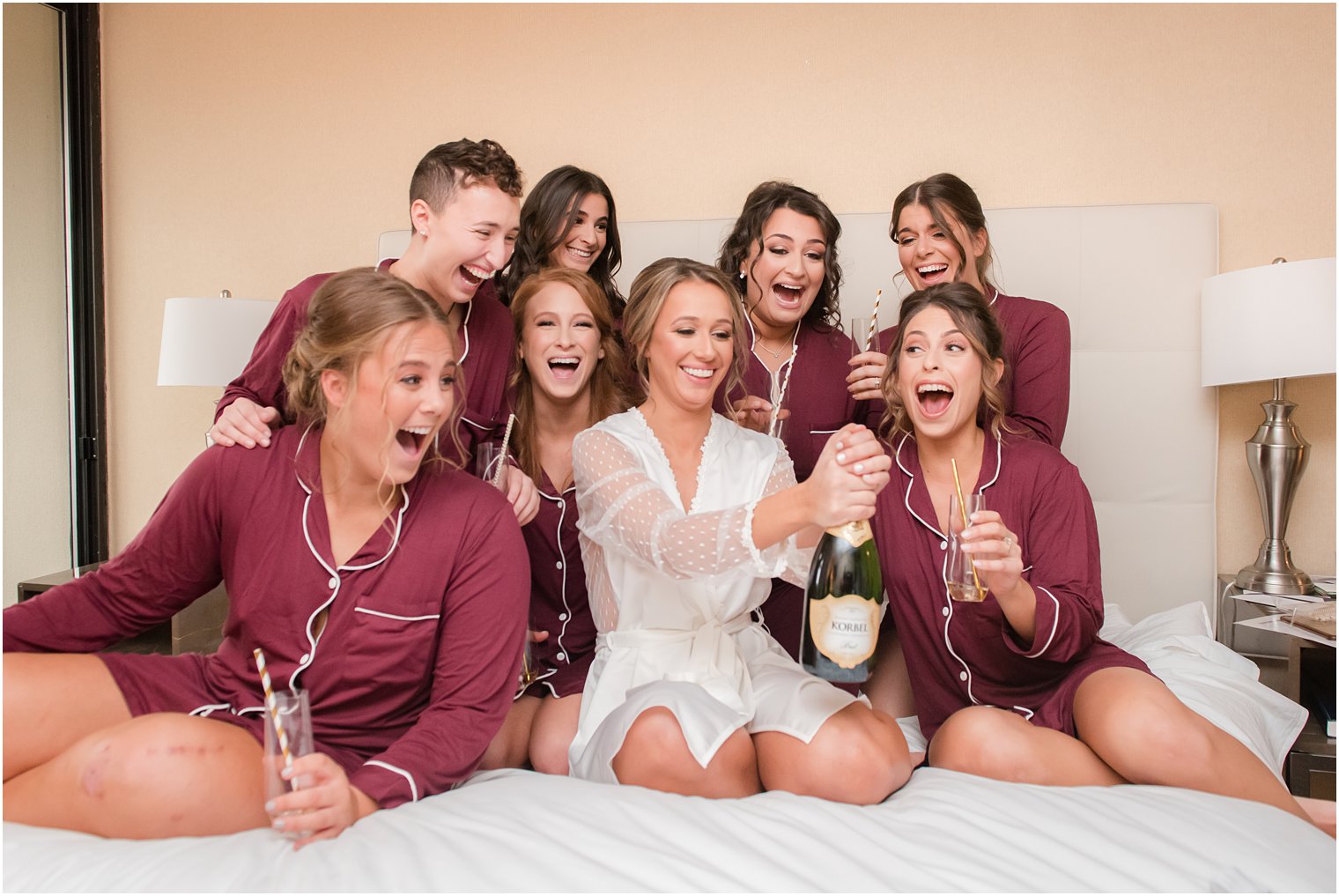 Bridesmaids opening a bottle of champagne