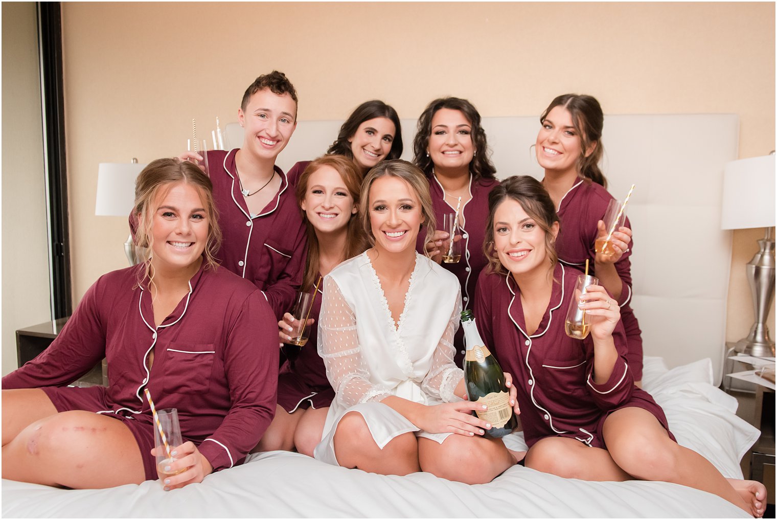 Bridesmaids in pajamas toasting and drinking champagne