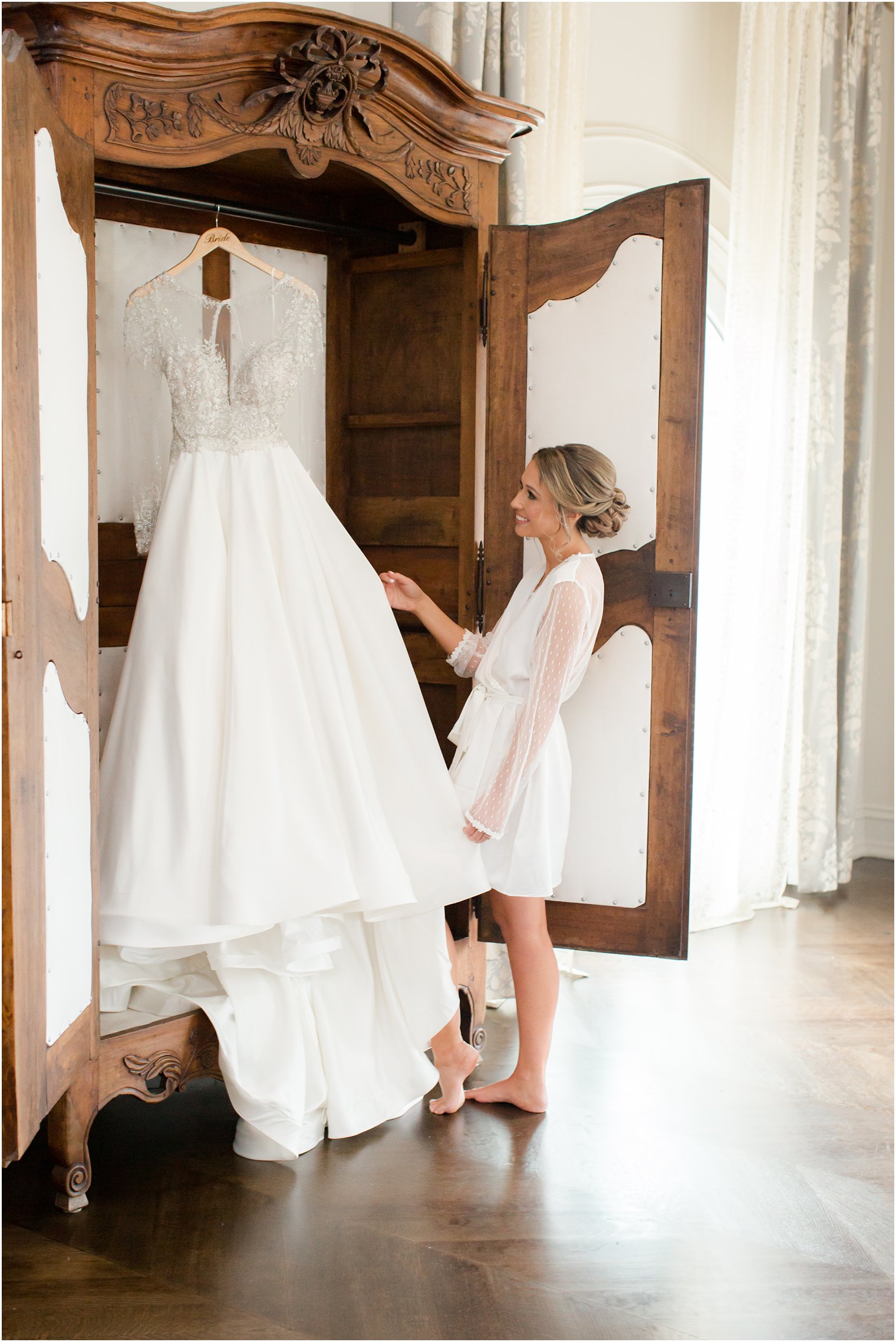 Bride admiring her wedding gown 