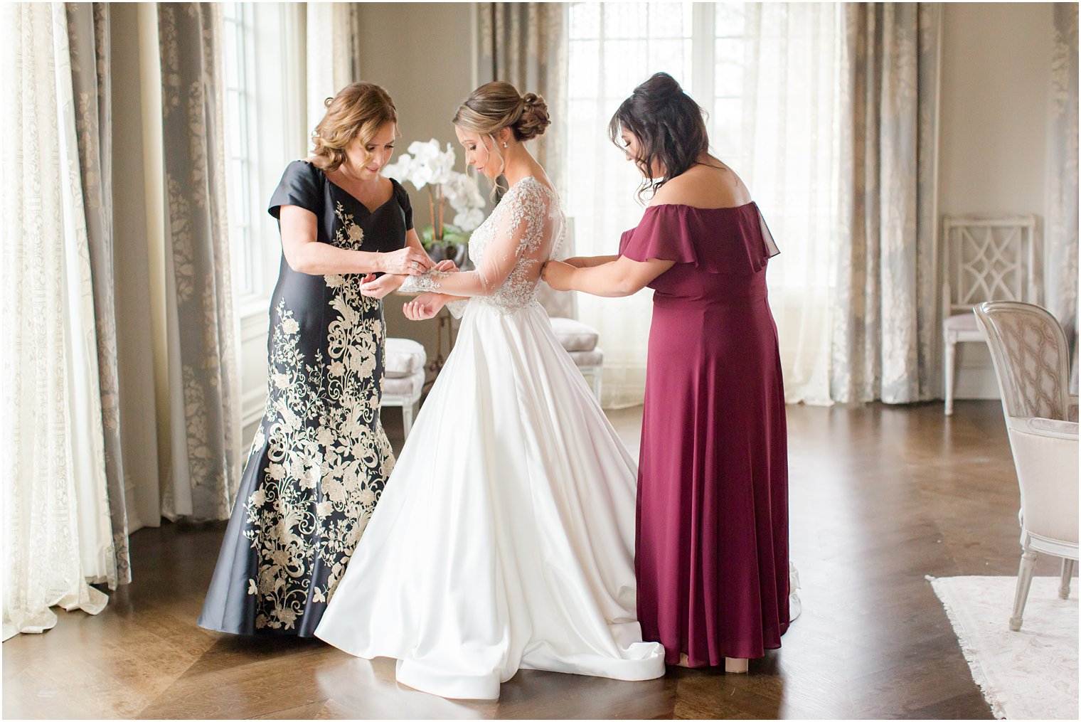 Bride getting ready with her mother and maid of honor
