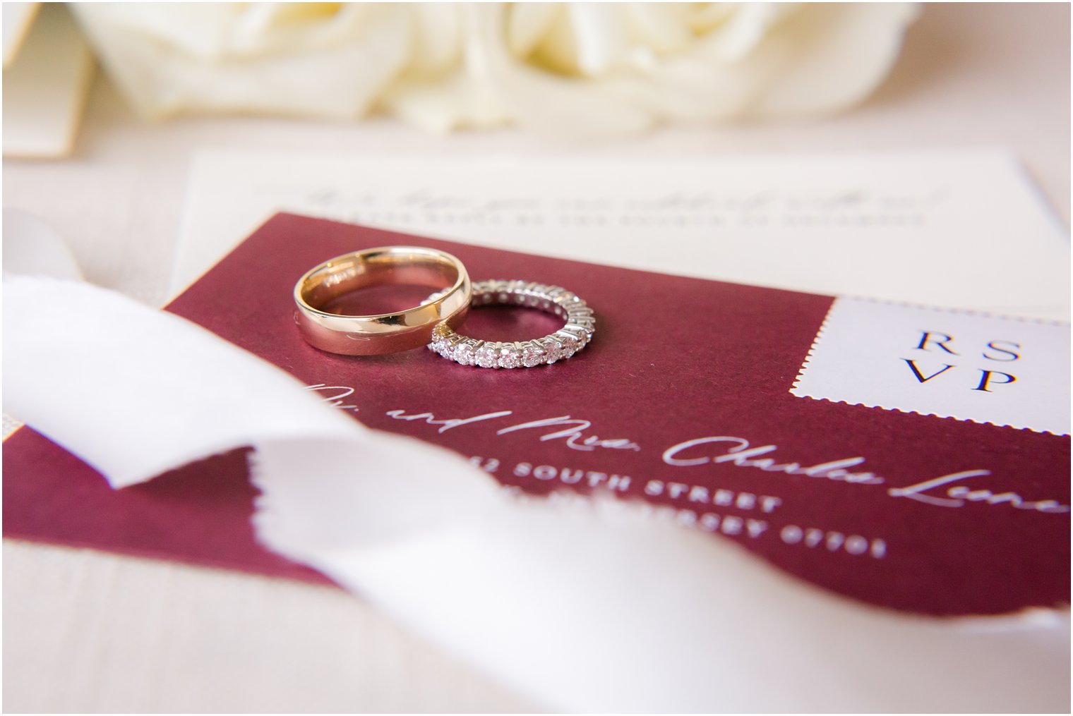 wedding bands on burgundy invitation 