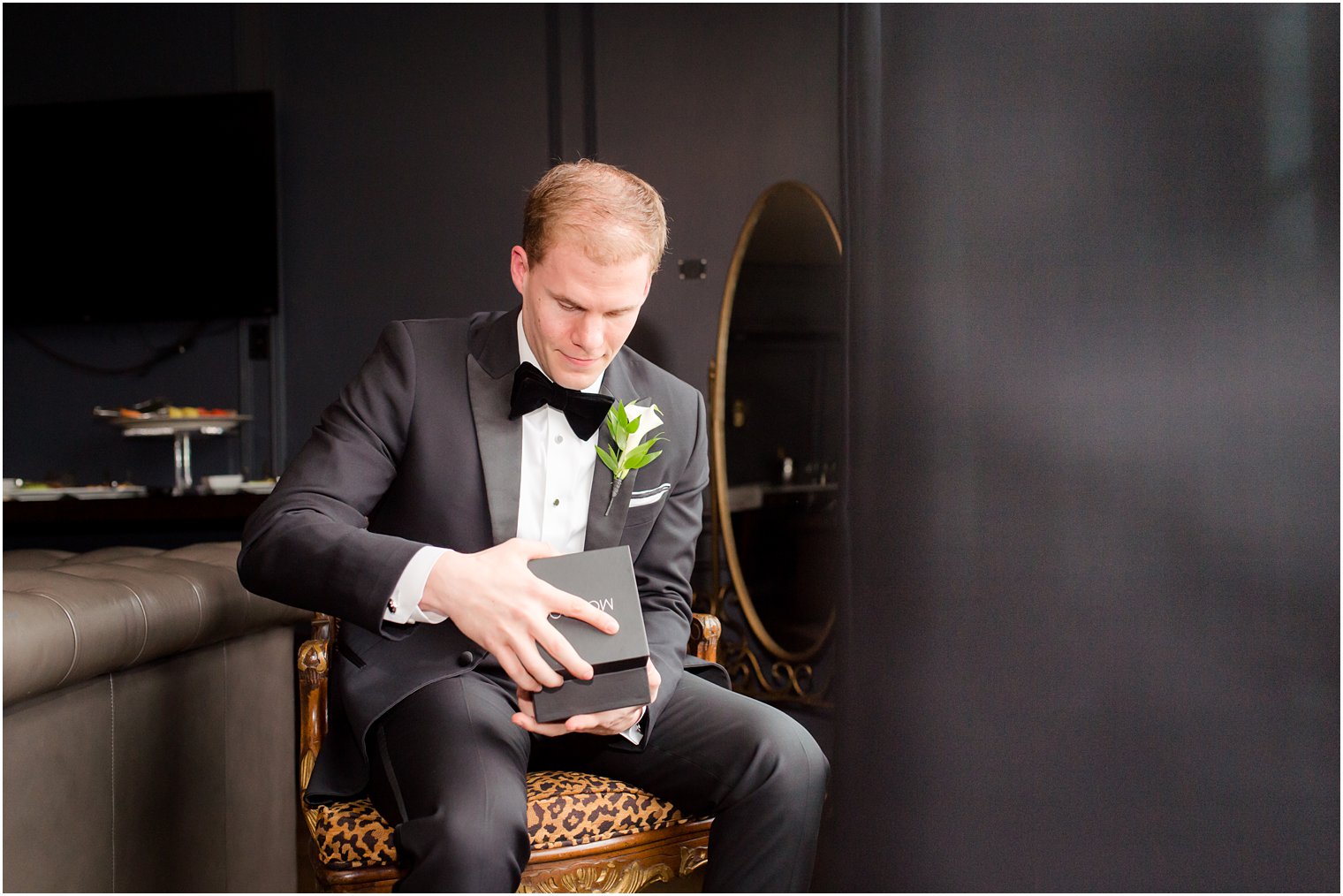 groom opening a gift from his bride