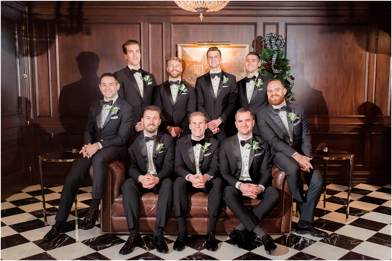 groom and groomsmen in library of Park Chateau Estate