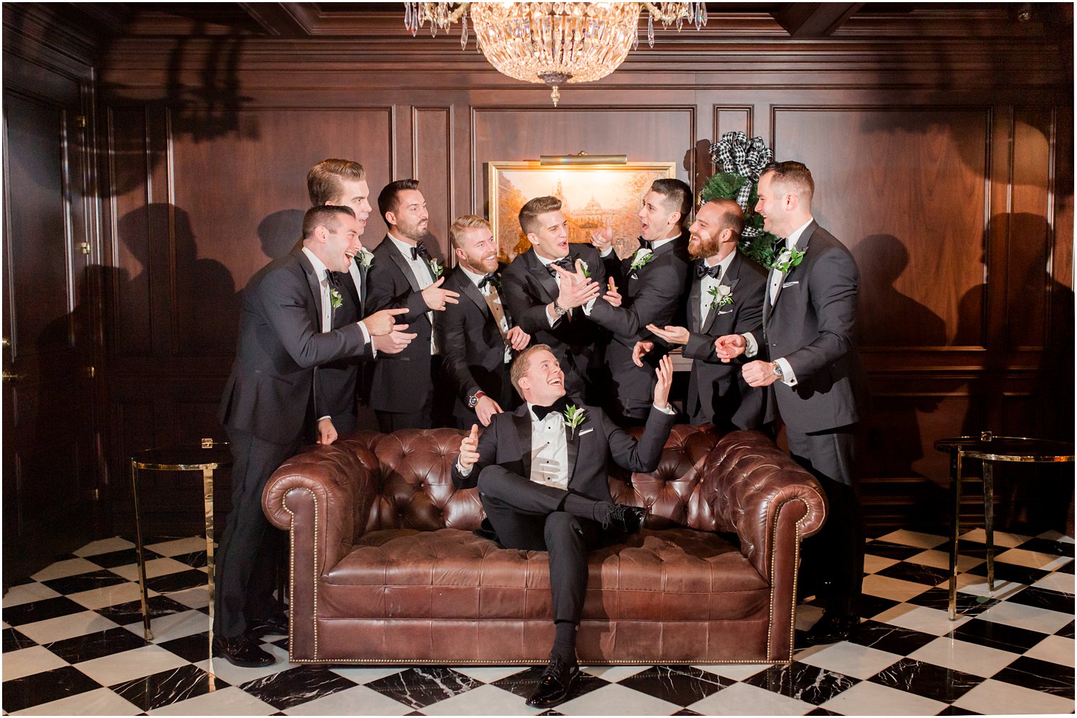 groom and groomsmen in library of Park Chateau Estate