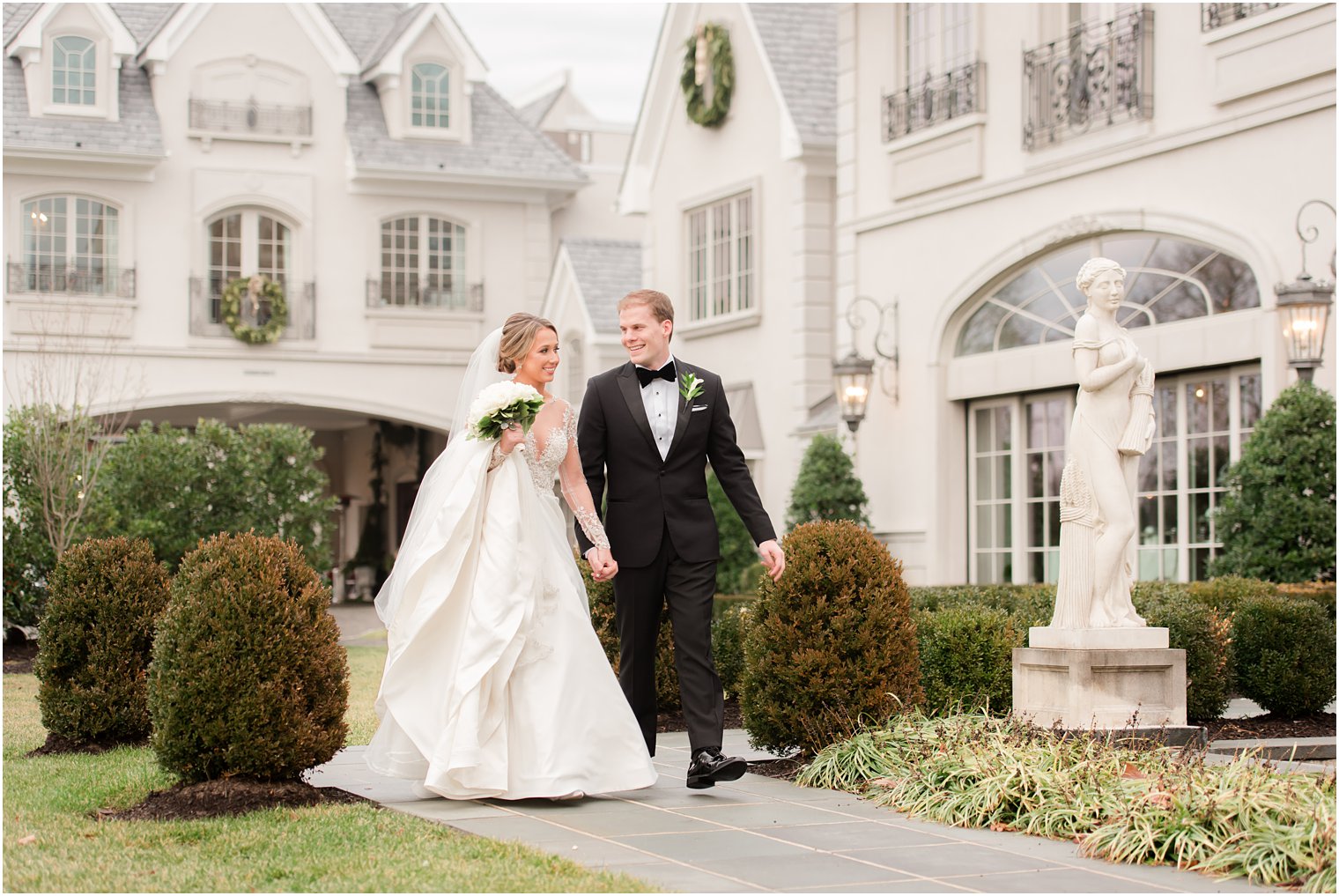 Bride and groom walking at Park Chateau Estate and Gardens | Photos by Idalia Photography