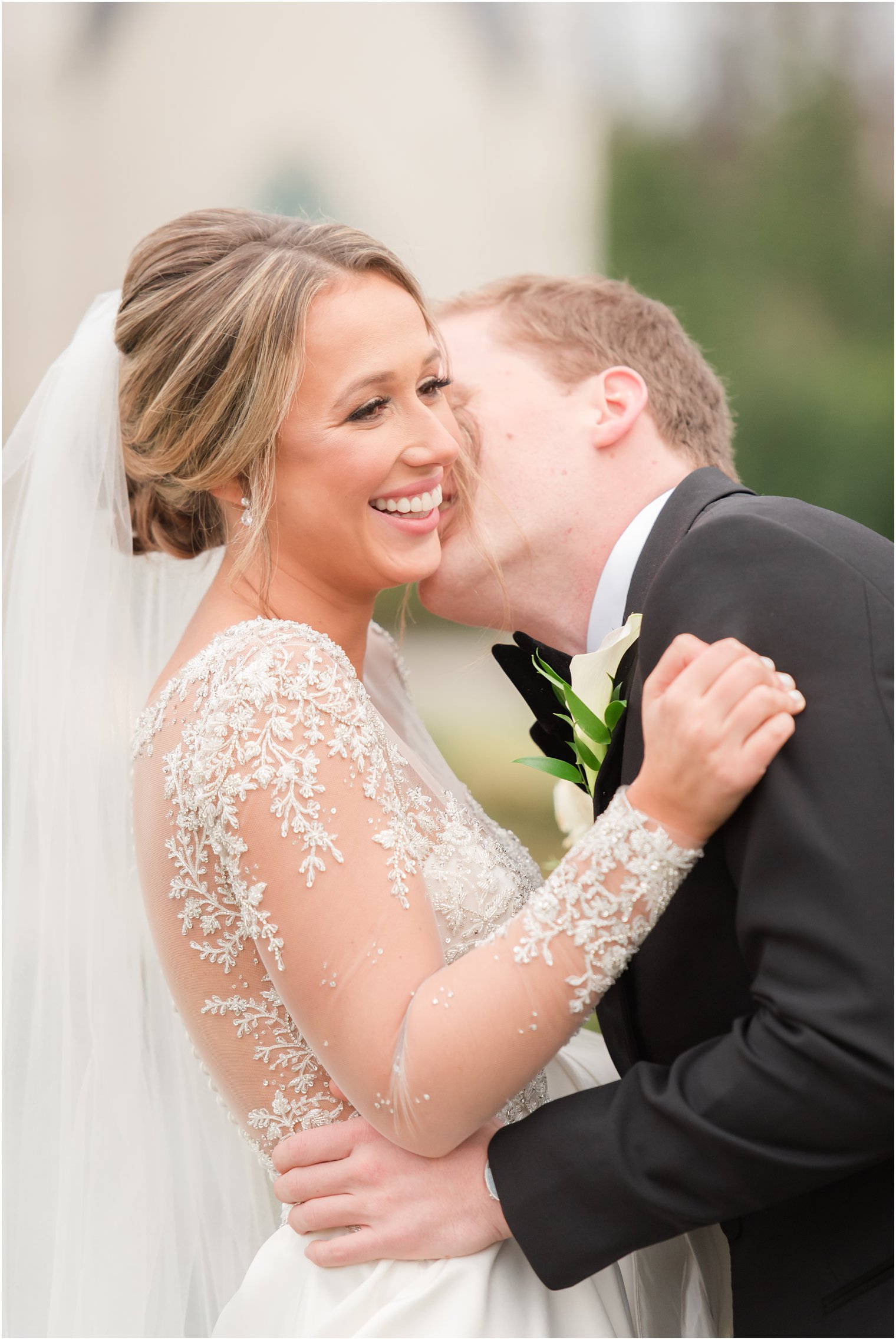 Groom kissing bride on the neck at Park Chateau Estate