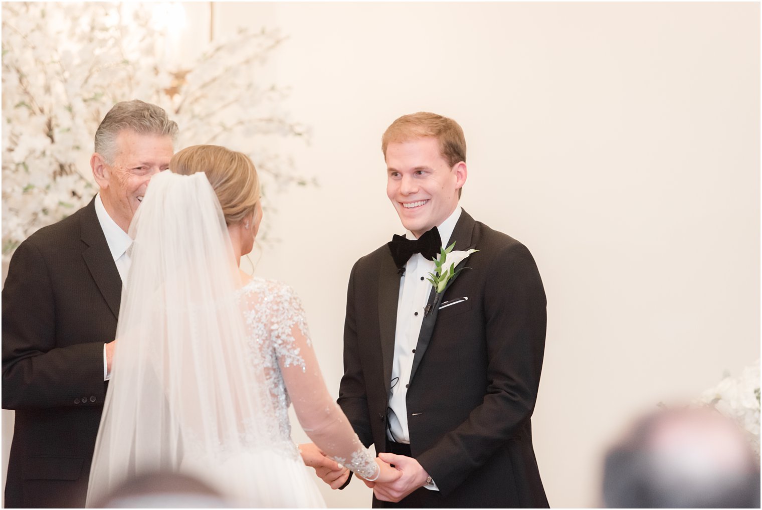 Groom laughing during wedding ceremony at Park Chateau Chapel| Winter wedding by Idalia Photography Associates
