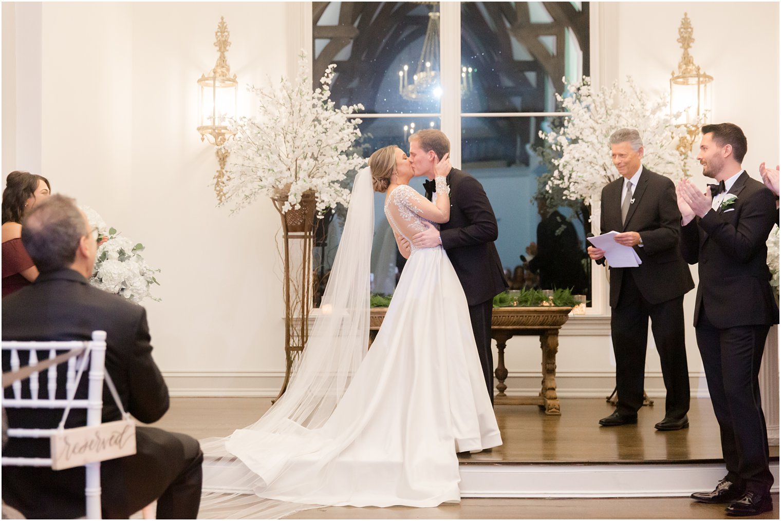 Bride and groom kissing during wedding ceremony at Park Chateau Chapel| Winter wedding by Idalia Photography Associates