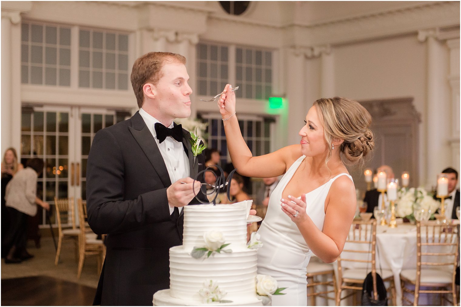 Bride feeding groom at Park Chateau wedding