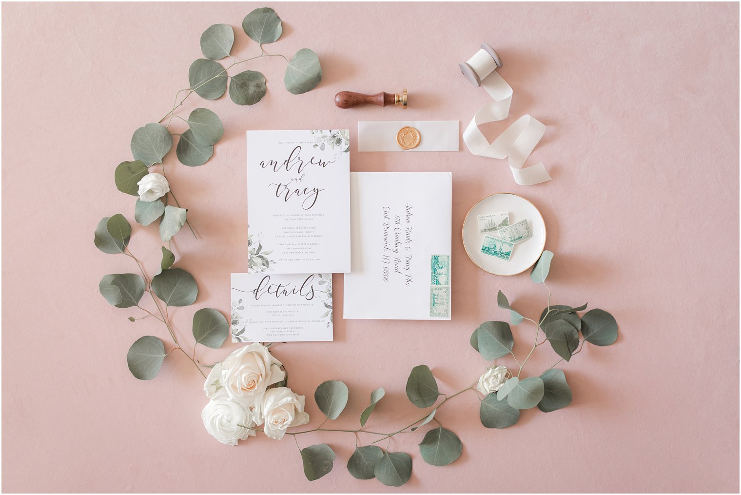 Invitation flatlay with florals, wax seal, and vintage stamps | Photo by Idalia Photography