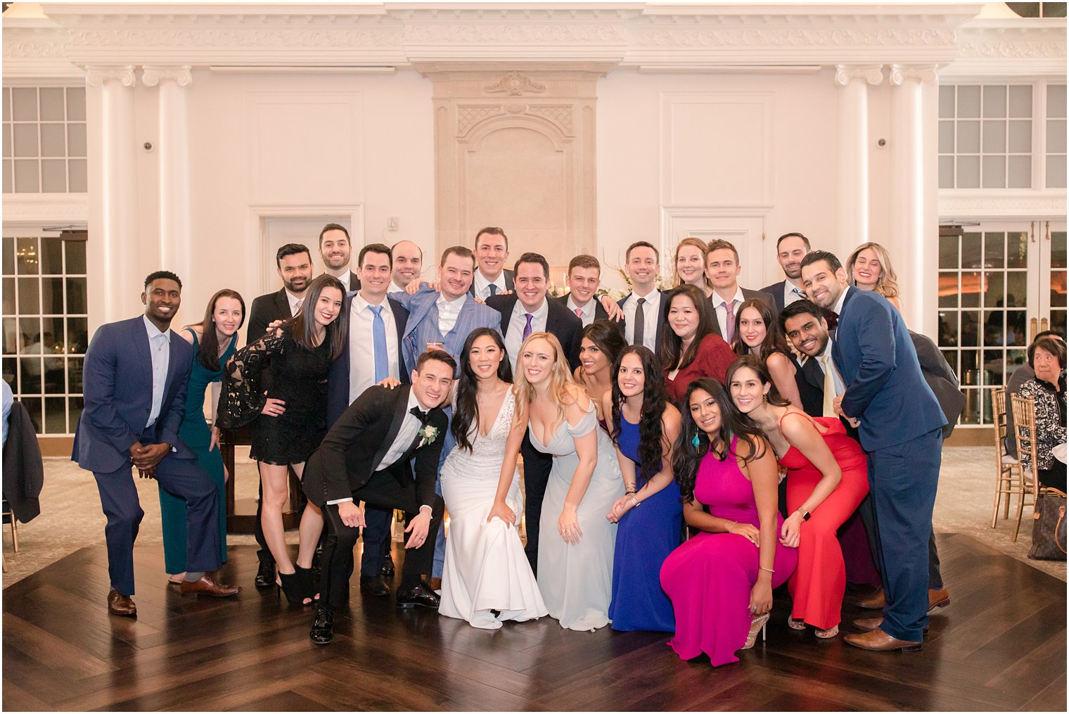 Group photo of bride and groom with guests