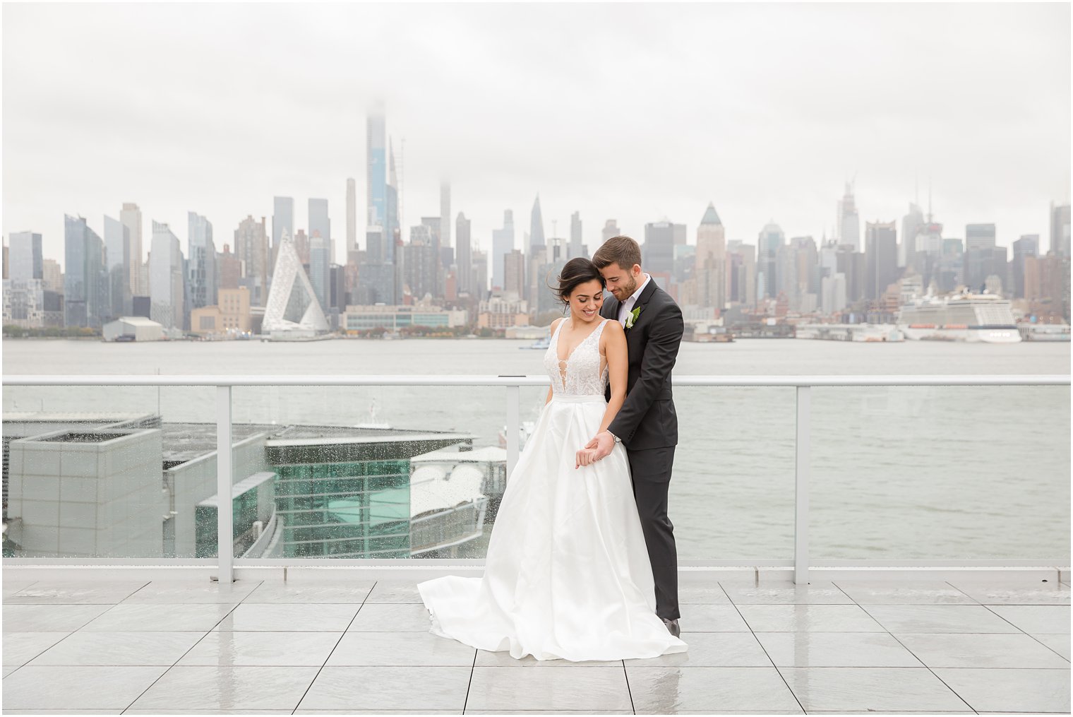 Bride and groom posing with NYC skyline | Envue Hotel Wedding Editorial
