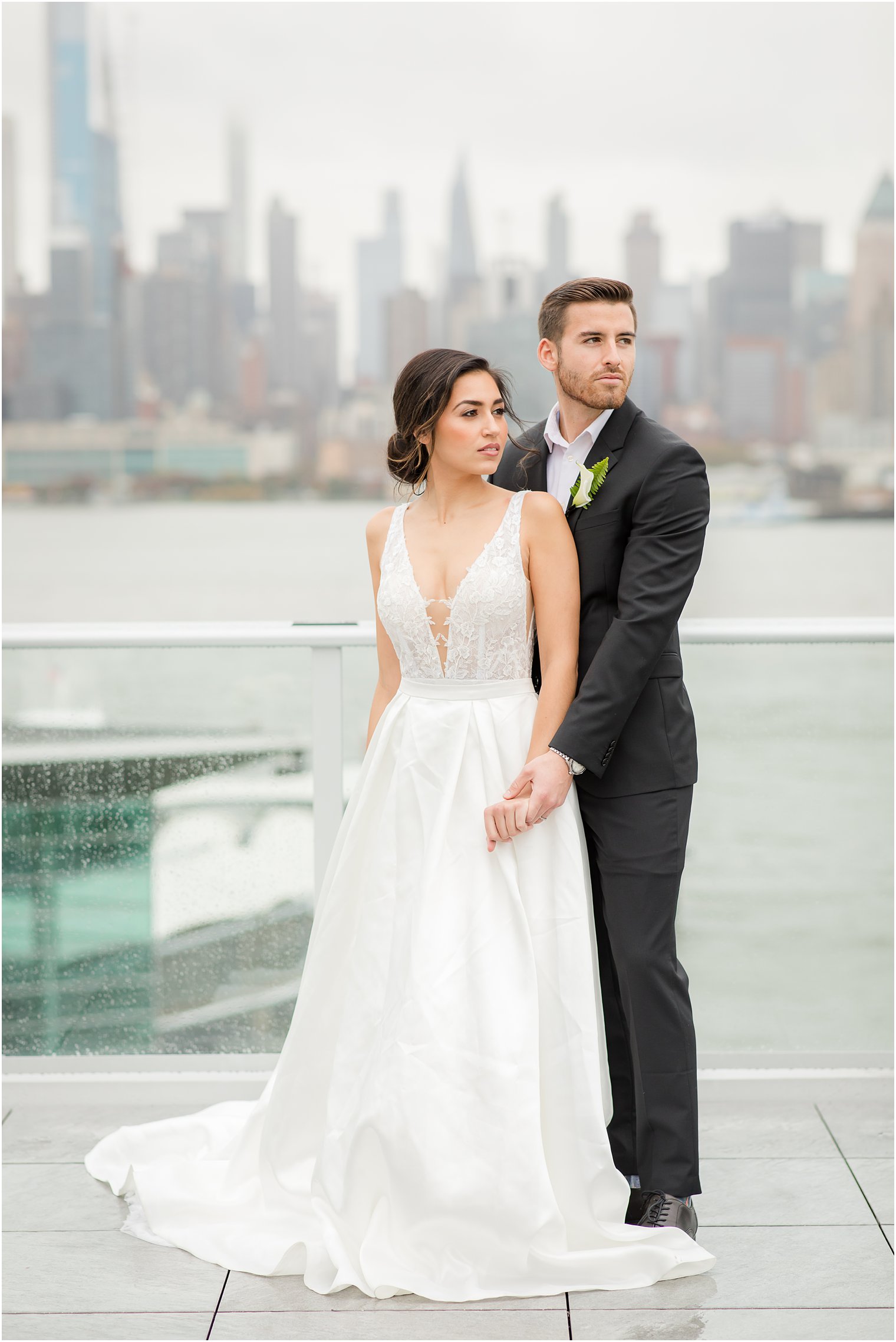 Bride and groom posing with NYC skyline | Envue Hotel Wedding Editorial