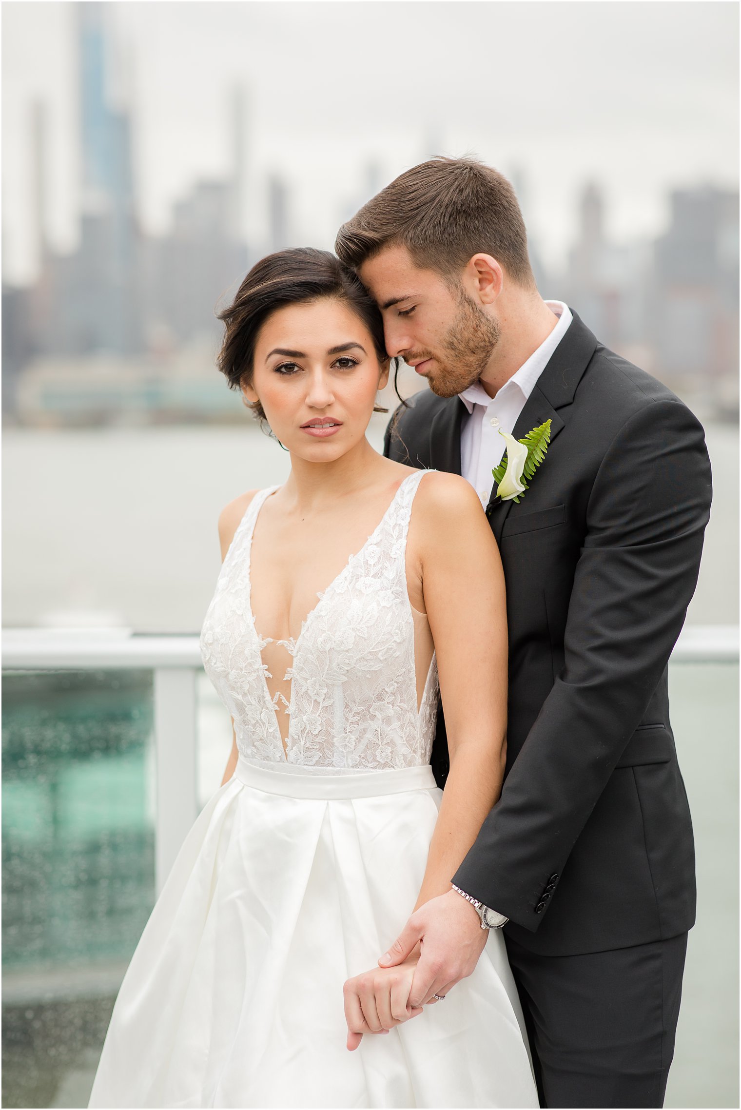 Bride and groom posing with NYC skyline | Envue Hotel Wedding Editorial