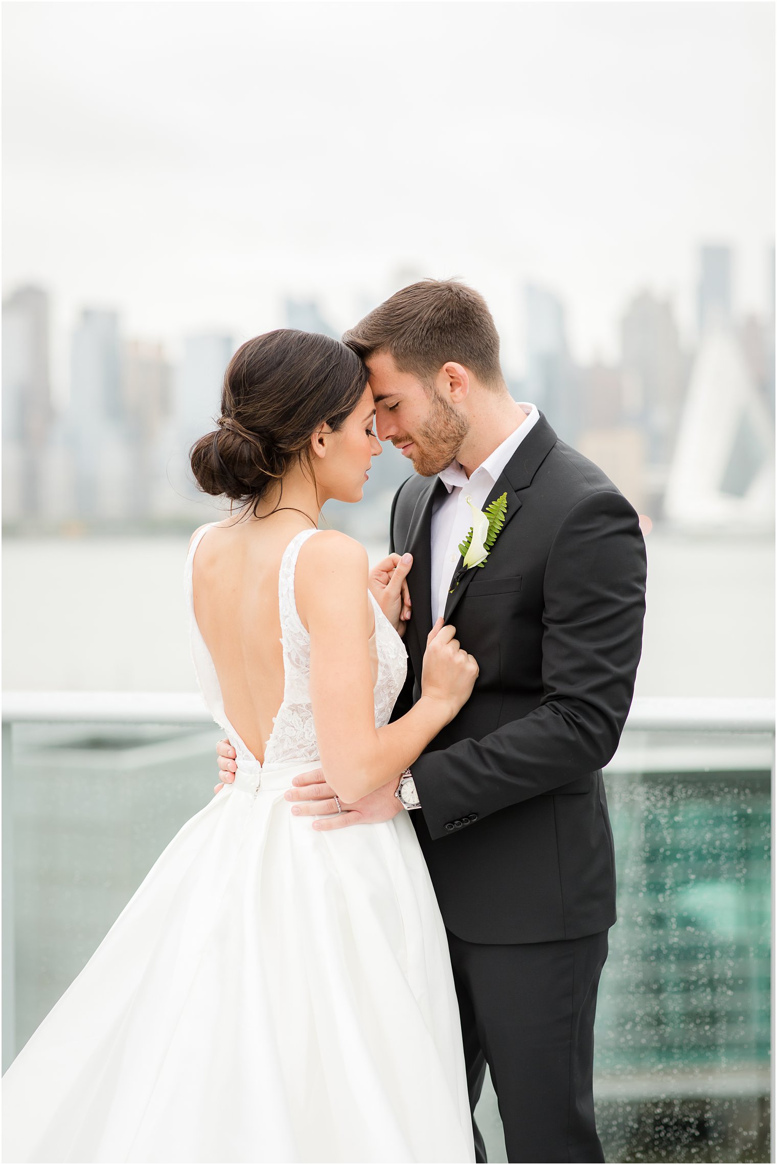 Bride and groom posing with NYC skyline | Envue Hotel Wedding Editorial