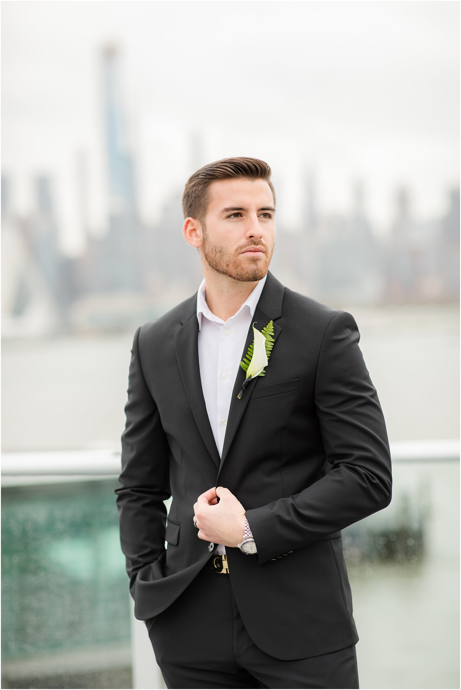 Groom posing with NYC skyline | Envue Hotel Wedding Editorial