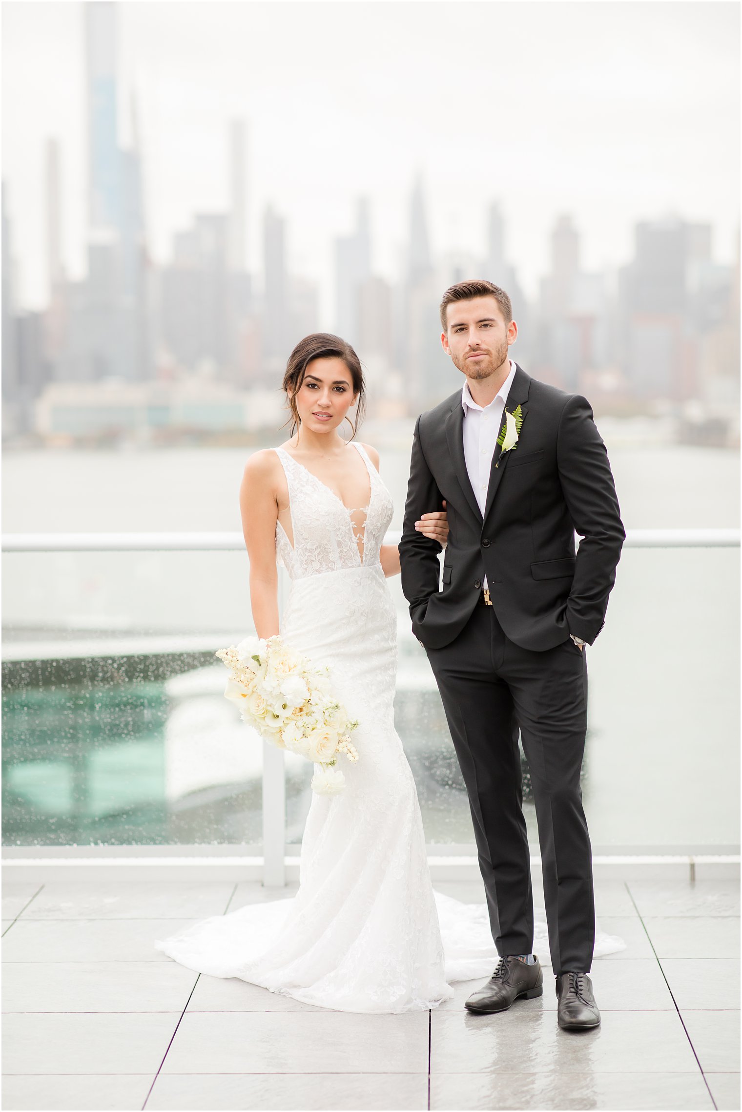 Bride and groom posing with NYC skyline | Envue Hotel Wedding Editorial