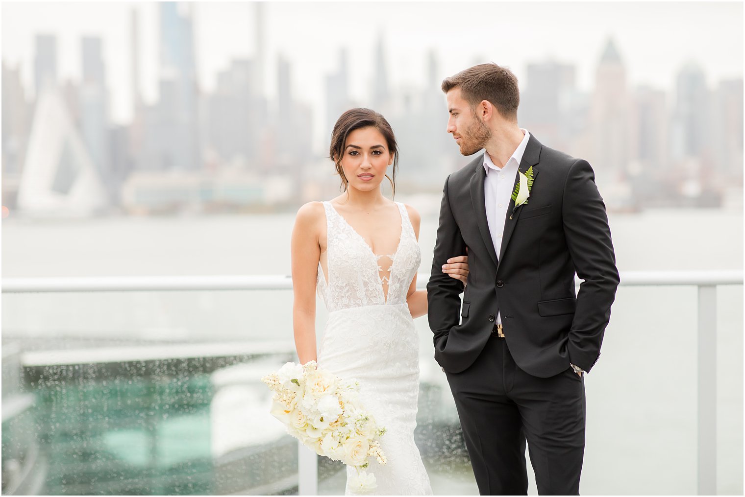 Bride and groom posing with NYC skyline | Envue Hotel Wedding Editorial