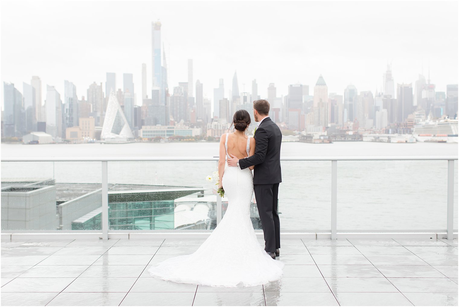 Bride and groom posing with NYC skyline | Envue Hotel Wedding Editorial