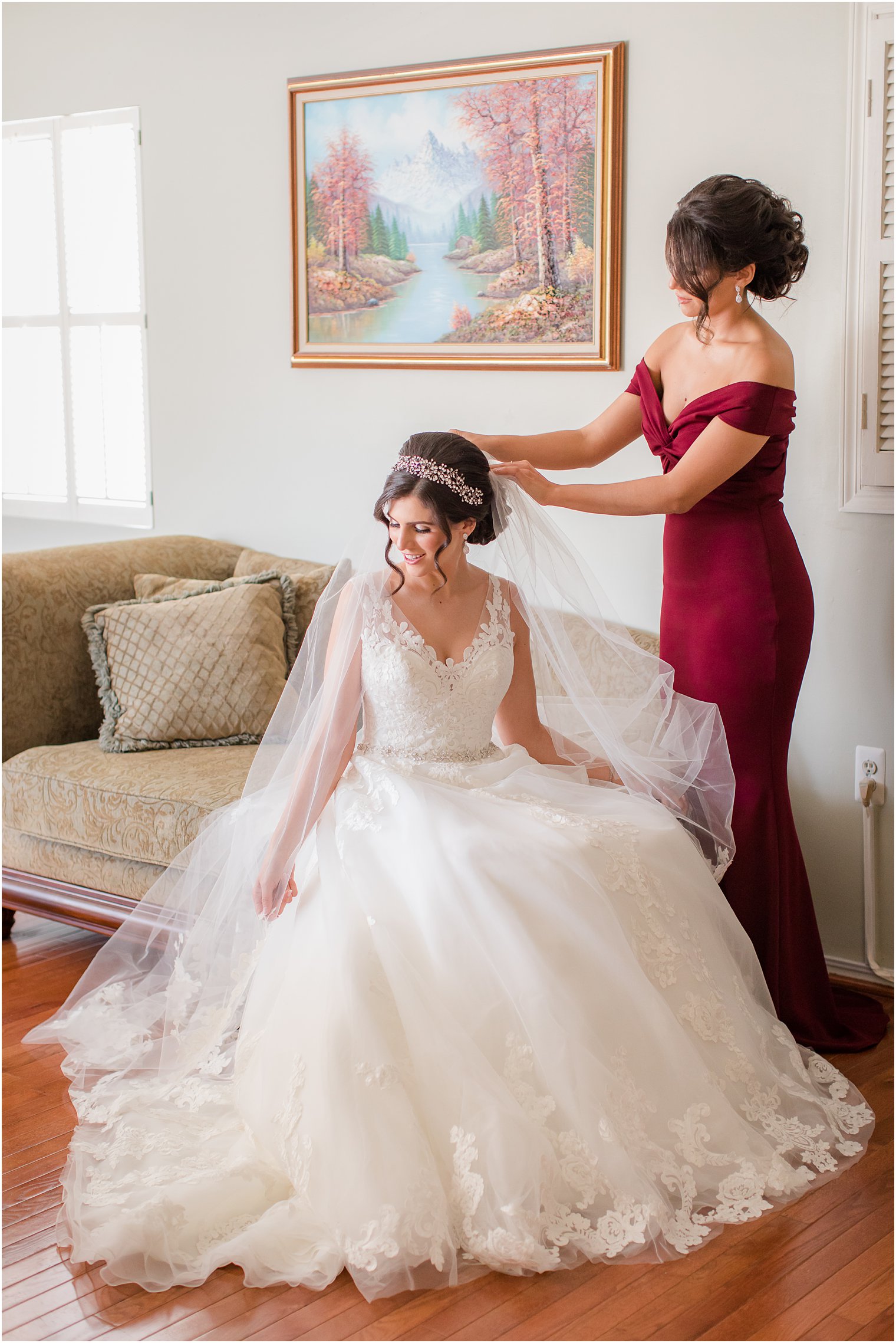 Maid of Honor putting on bride's veil 