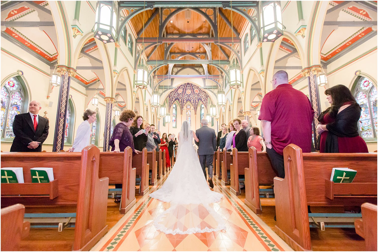 Bride walking down the aisle with her feather at St. Mary's in Morristown