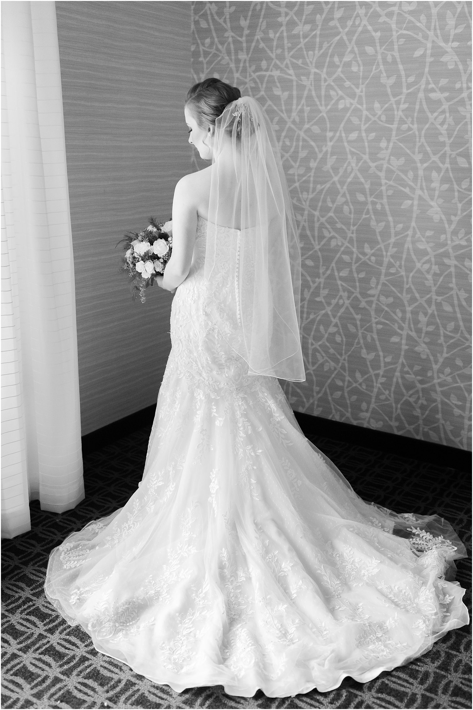 Black and white photo of bride from behind