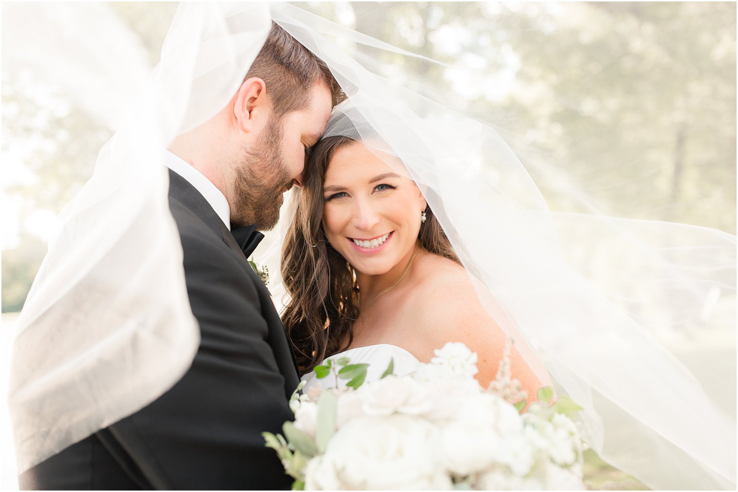 Photo of bride and groom from under the veil