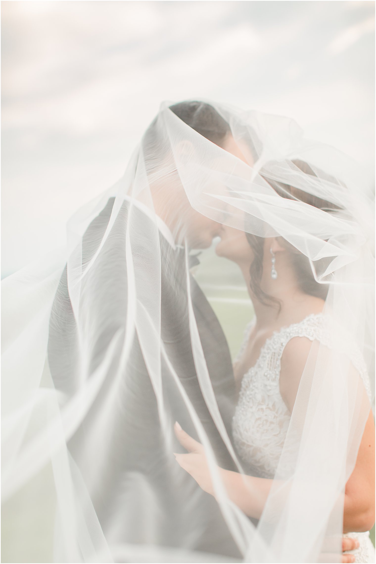Romantic photo of bride and groom under the veil 