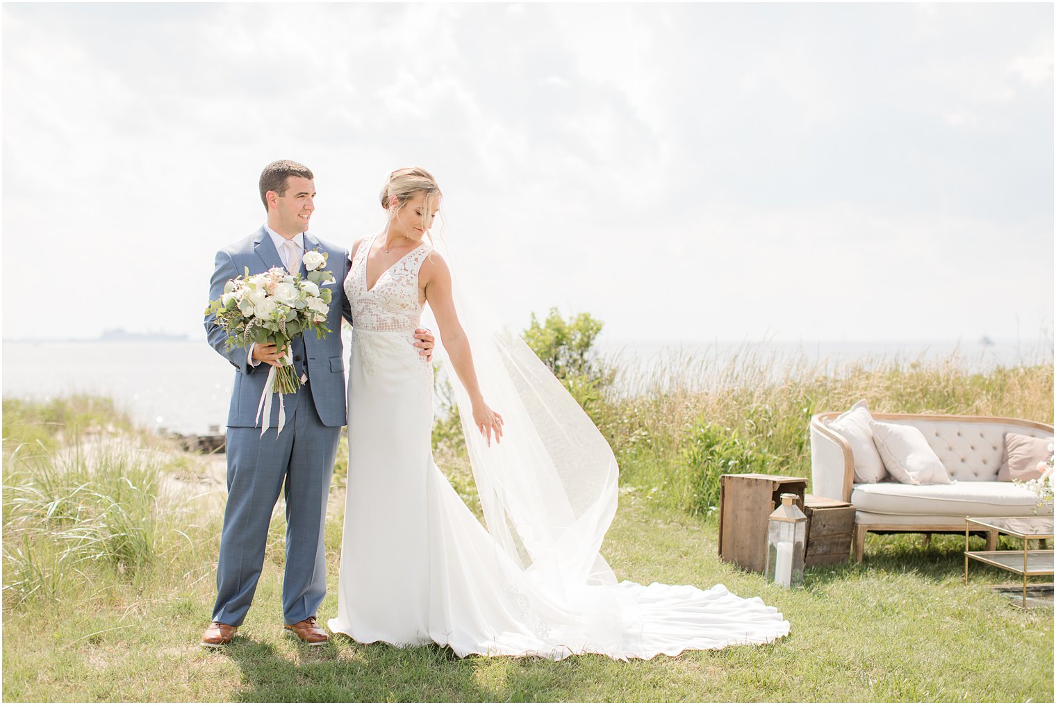 Bride and groom posing for photos at Sandy Hook Chapel 