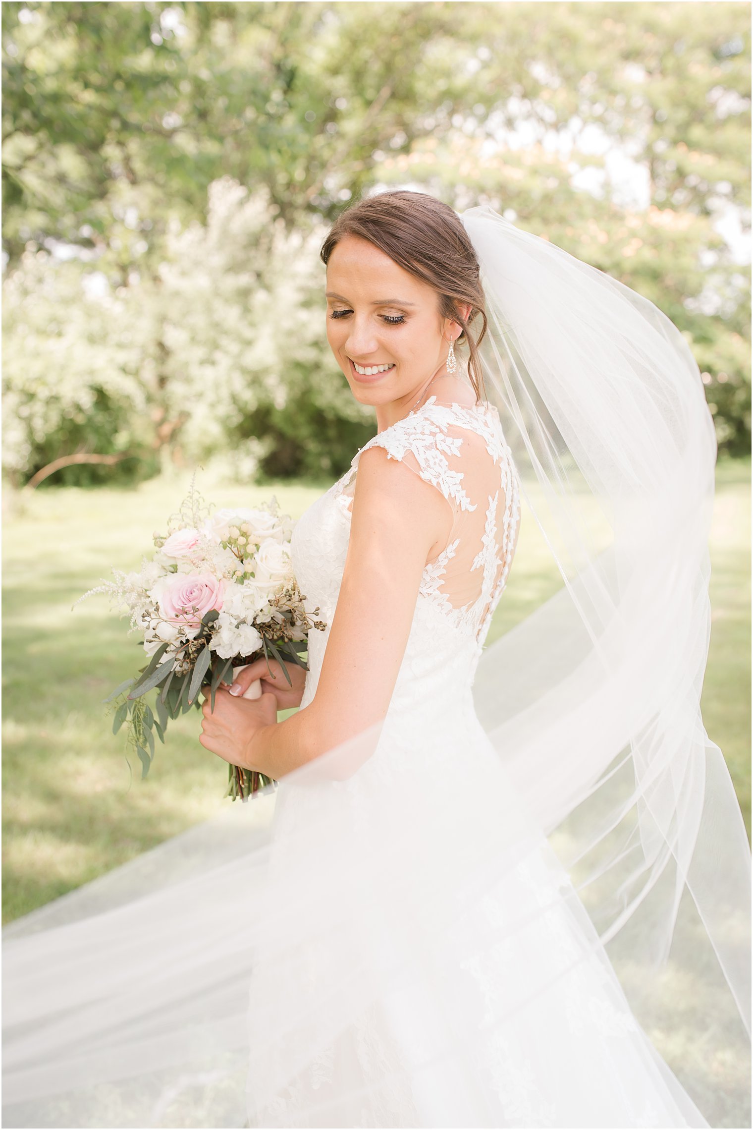 Bride and her veil being blown away by the wind