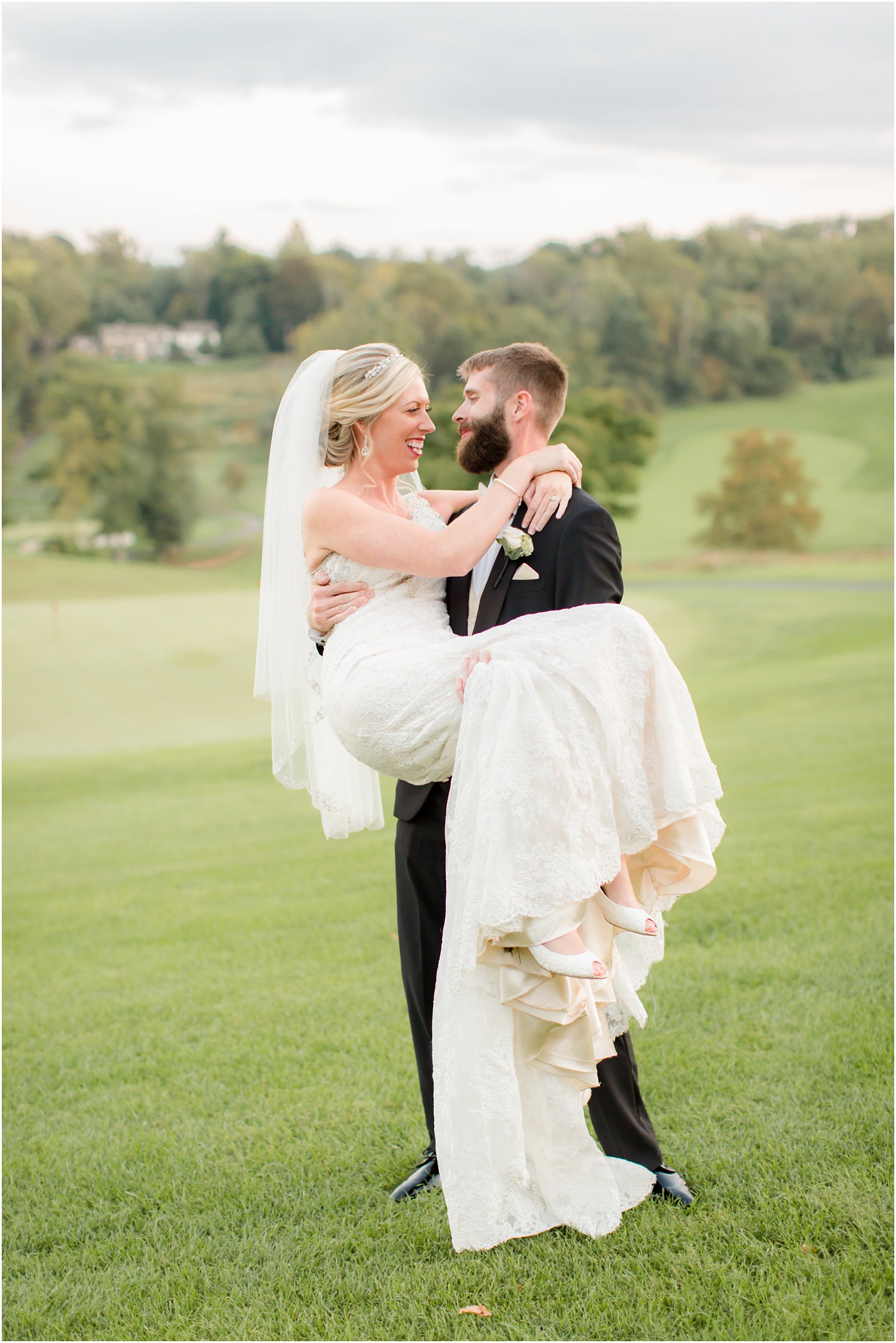 Groom lifting his bride on their wedding day