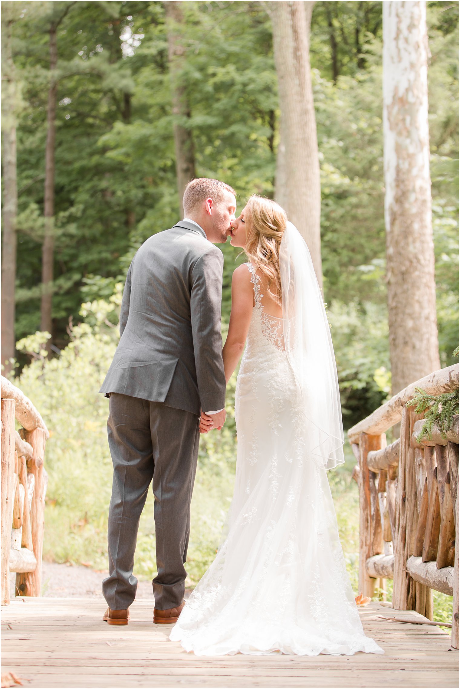 Bride and groom walking away and kissing at Stone House Stirling Ridge